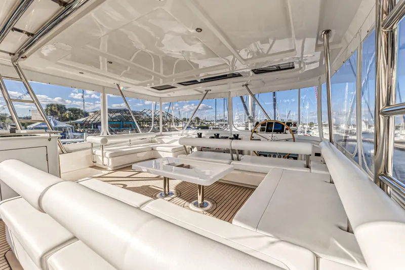 Aquarius Yacht Photos Pics Luxurious 2016 Leopard 58 yacht interior with white seating and marina view.