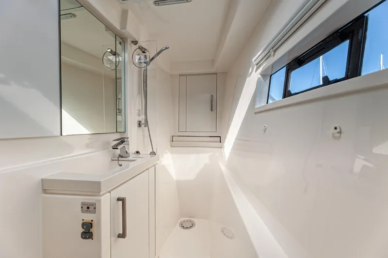 Aquarius Yacht Photos Pics Modern bathroom interior on a 2016 Leopard 58 yacht, featuring sleek design and natural lighting.