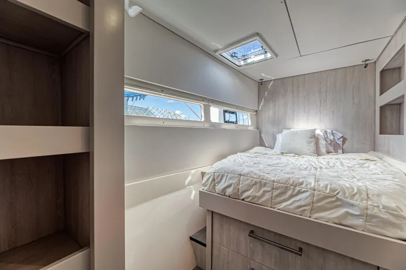 Aquarius Yacht Photos Pics Luxurious cabin interior of 2016 Leopard 58 yacht with cozy bed and natural light.