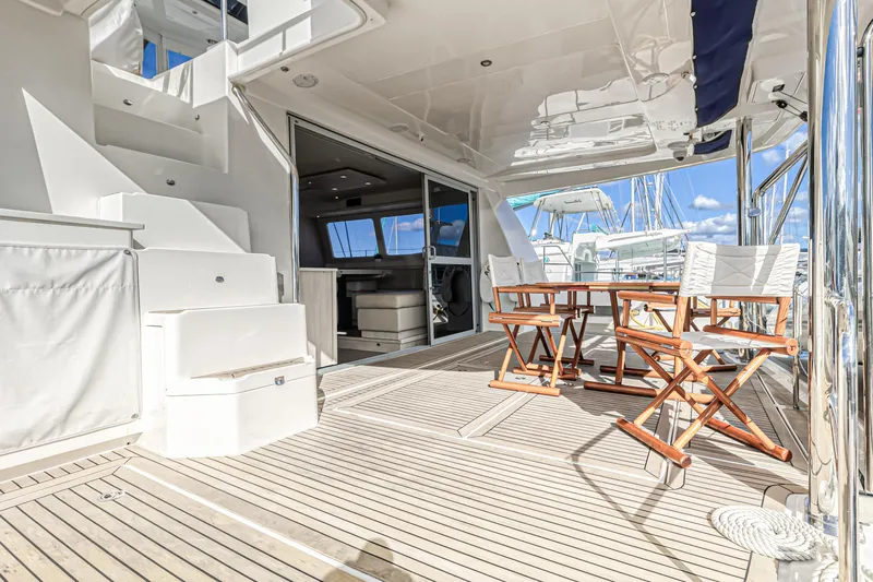 Aquarius Yacht Photos Pics Luxurious 2016 Leopard 58 yacht deck with seating, stairs, and marina view.