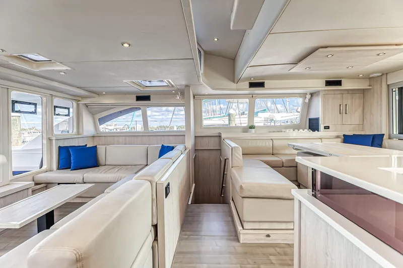 Aquarius Yacht Photos Pics Luxurious interior of a 2016 Leopard 58 yacht with modern seating and blue accents.