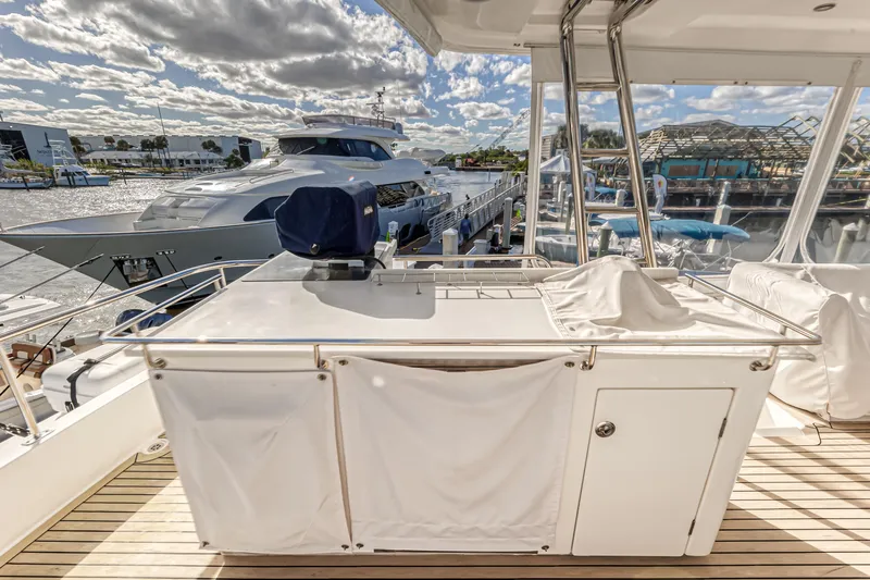 Aquarius Yacht Photos Pics Luxury Leopard 58 yacht deck with marina view, 2016 model, under partly cloudy sky.
