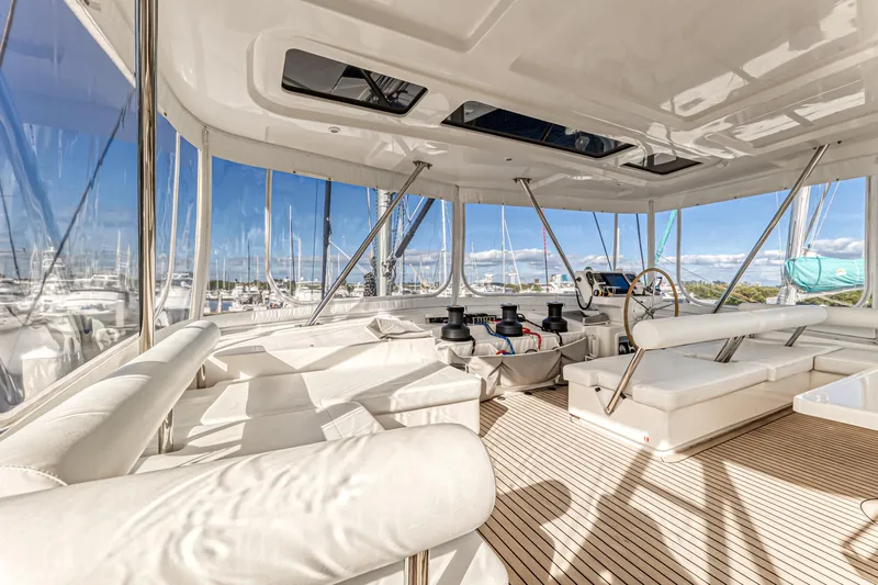 Aquarius Yacht Photos Pics Luxurious interior of 2016 Leopard 58 yacht with white seating and panoramic windows.