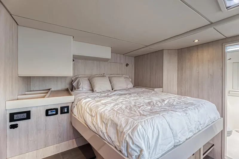 Aquarius Yacht Photos Pics Luxurious bedroom interior of 2016 Leopard 58 yacht with modern design and cozy bedding.