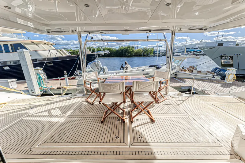 Aquarius Yacht Photos Pics Luxury yacht deck with seating area, Leopard 58 model, 2016, docked at marina.