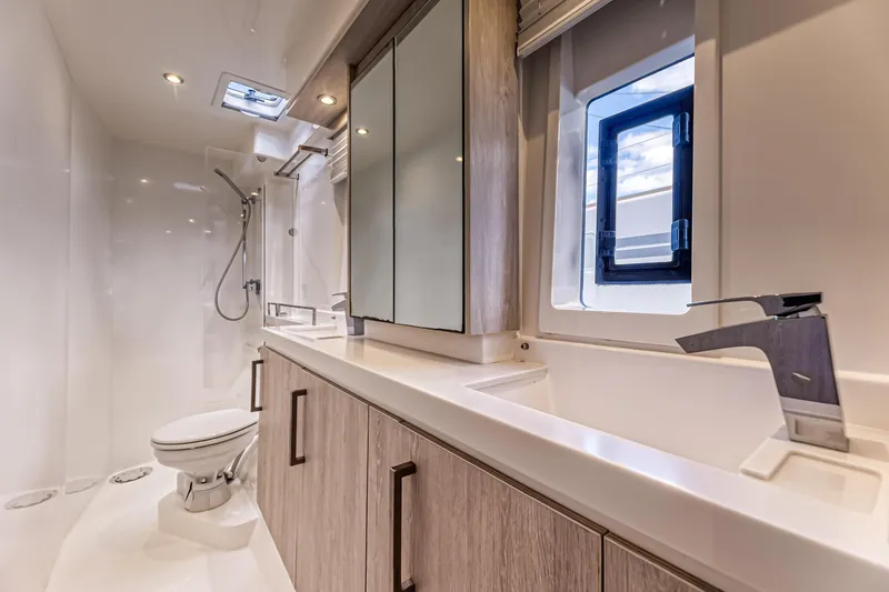 Aquarius Yacht Photos Pics Luxurious bathroom in 2016 Leopard 58 yacht with modern fixtures and sleek design.