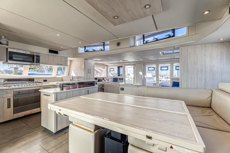 Aquarius Yacht Photos Pics Luxurious interior of a 2016 Leopard 58 yacht featuring a modern kitchen and spacious seating area.