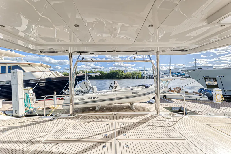 Aquarius Yacht Photos Pics Luxurious Leopard 58 yacht deck with a Brig tender, docked at a marina, 2016 model.