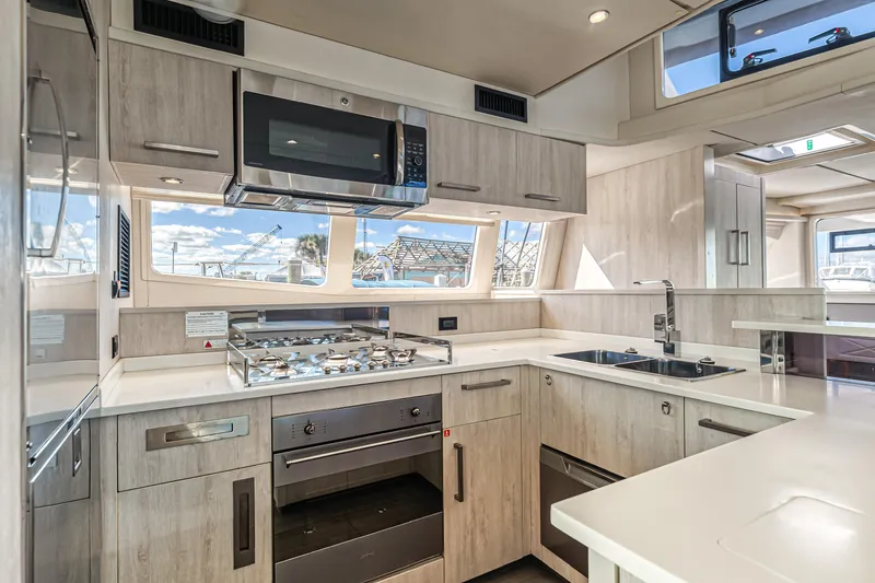 Aquarius Yacht Photos Pics Modern kitchen interior on a 2016 Leopard 58 yacht, featuring sleek appliances and ample natural light.