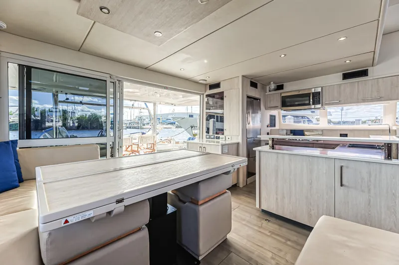 Aquarius Yacht Photos Pics Luxurious interior of 2016 Leopard 58 yacht with modern kitchen and dining area.