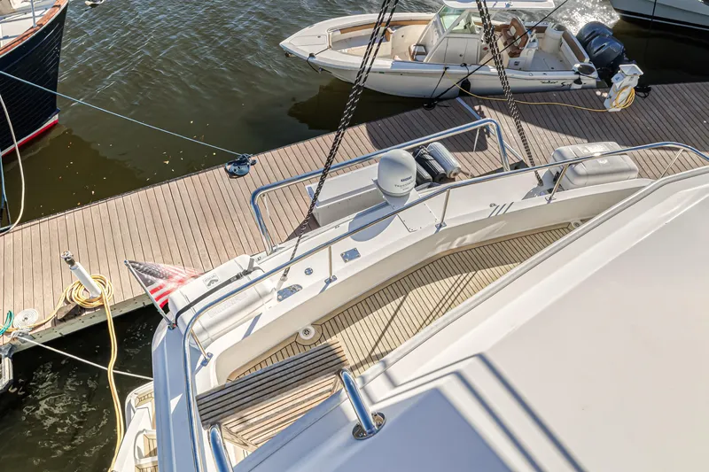 Aquarius Yacht Photos Pics Luxury Leopard 58 yacht docked, 2016 model, with wooden deck and nearby boats.