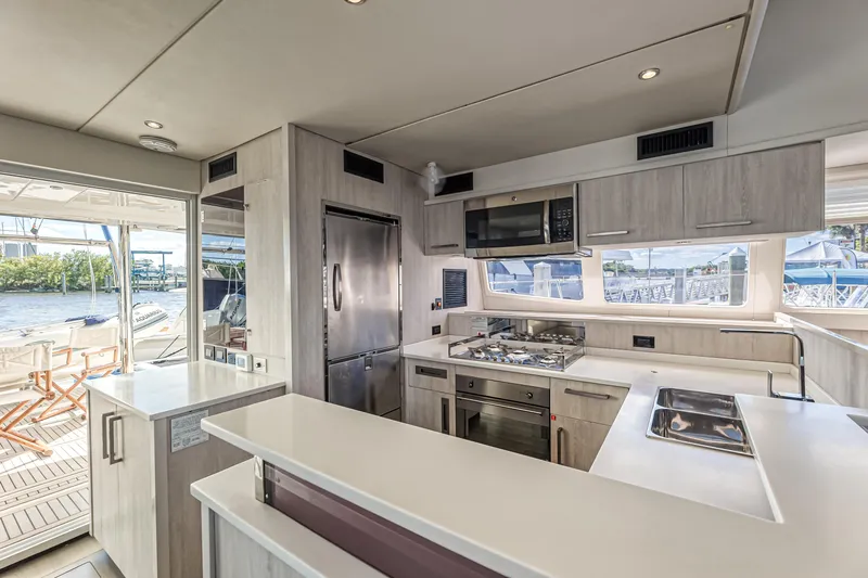 Aquarius Yacht Photos Pics Luxurious kitchen interior of 2016 Leopard 58 yacht with modern appliances and sleek design.