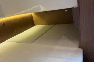  Yacht Photos Pics 2021 Jeanneau NC 895 cabin interior with cozy bedding and ambient lighting.