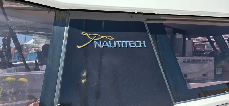 Night Out Yacht Photos Pics Nautitech 44 Open 2023 yacht window with logo, showcasing sleek design and modern features.
