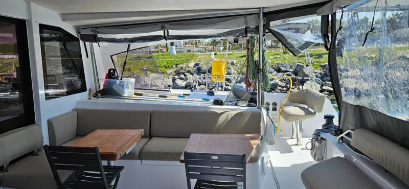 Night Out Yacht Photos Pics 2023 Nautitech 44 Open yacht interior with seating and tables, featuring modern design.