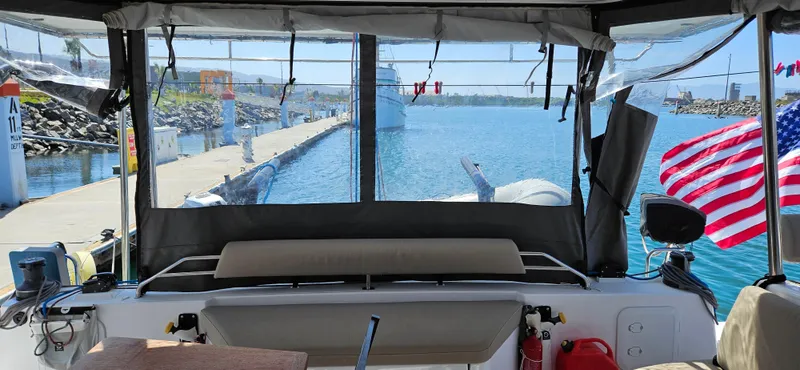 Night Out Yacht Photos Pics 2023 Nautitech 44 Open catamaran docked, featuring a spacious cockpit with an American flag.