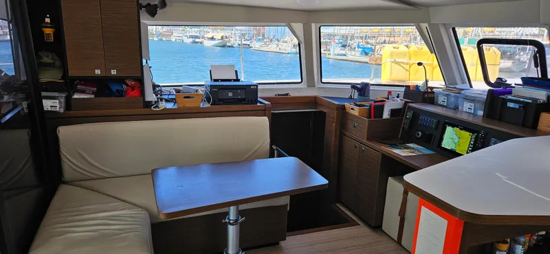 Night Out Yacht Photos Pics Interior of 2023 Nautitech 44 Open catamaran with modern seating and navigation equipment.