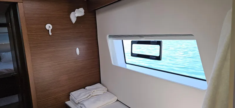 Night Out Yacht Photos Pics Interior of 2023 Nautitech 44 Open yacht with window view and folded towels.