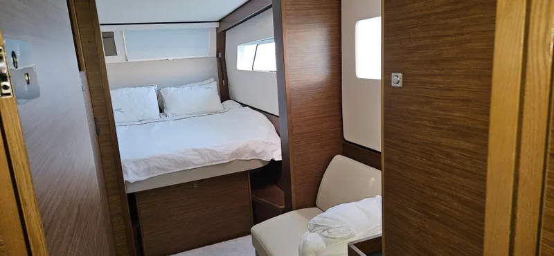 Night Out Yacht Photos Pics Interior cabin of 2023 Nautitech 44 Open yacht, featuring a cozy bed and wooden finish.