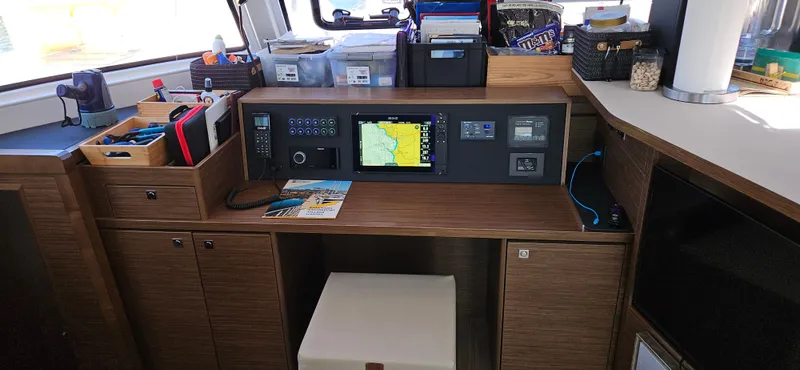 Night Out Yacht Photos Pics 2023 Nautitech 44 Open navigation station with electronic controls and storage compartments.