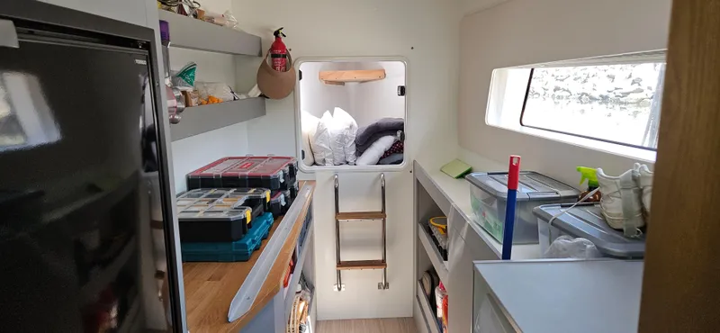 Night Out Yacht Photos Pics Interior of 2023 Nautitech 44 Open yacht, featuring storage shelves and a compact workspace.