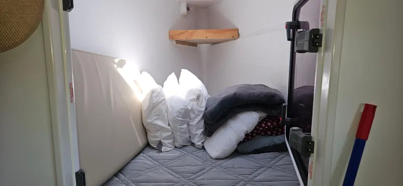 Night Out Yacht Photos Pics Cozy cabin interior of 2023 Nautitech 44 Open with pillows and bedding.