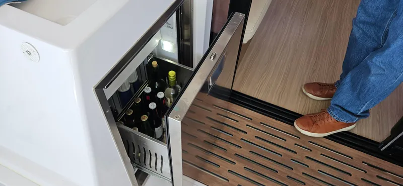 Night Out Yacht Photos Pics Open wine cooler on Nautitech 44 Open yacht, 2023 model, with wooden flooring and casual footwear.