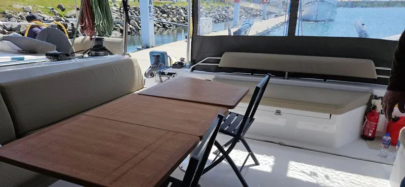 Night Out Yacht Photos Pics 2023 Nautitech 44 Open yacht interior with seating, tables, and ocean view.