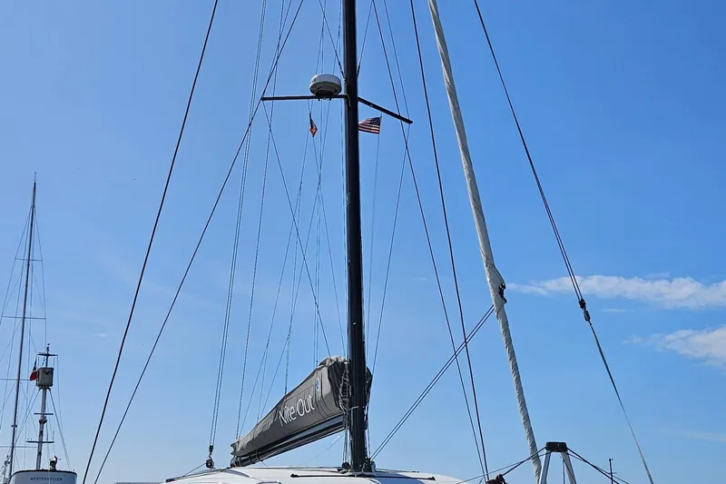 Night Out Yacht Photos Pics 2023 Nautitech 44 Open sailboat mast against clear blue sky.