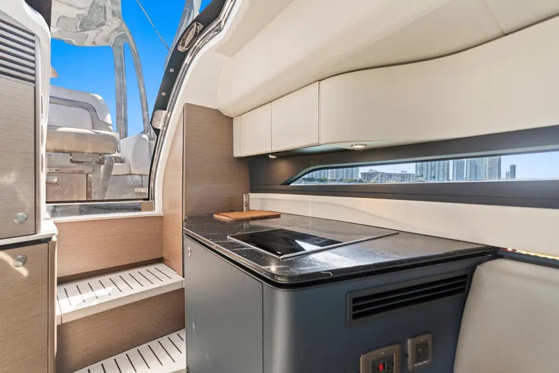  Yacht Photos Pics Interior of 2020 Princess R35 yacht with modern kitchen and cityscape view.