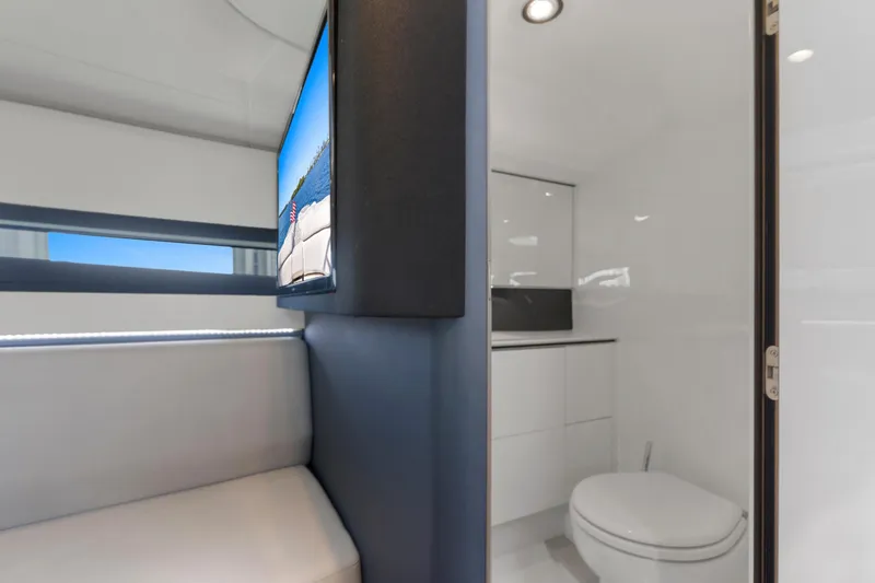  Yacht Photos Pics Luxurious interior of 2020 Princess R35 yacht featuring modern bathroom and seating area.