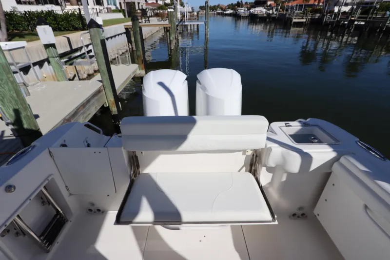  Yacht Photos Pics 2021 Edgewater 262CX Crossover boat with seating, docked in a marina.
