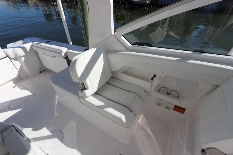  Yacht Photos Pics 2021 Edgewater 262CX Crossover boat interior with white seating and cup holders.