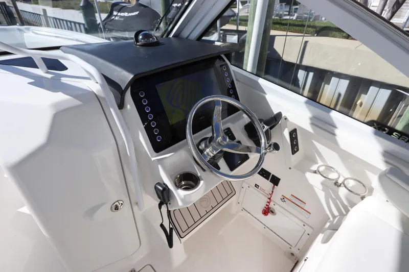  Yacht Photos Pics 2021 Edgewater 262CX Crossover boat helm with modern steering and navigation display.
