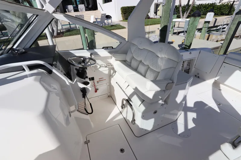  Yacht Photos Pics 2021 Edgewater 262CX Crossover boat interior with white seating and steering console.