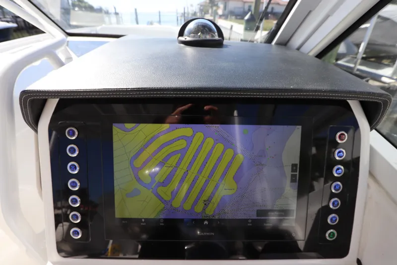  Yacht Photos Pics 2021 Edgewater 262CX Crossover boat dashboard with Garmin navigation display.