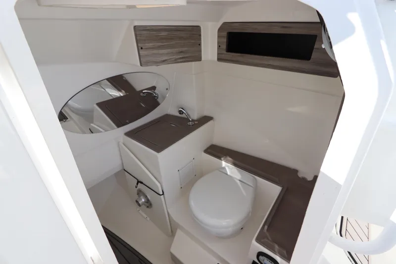  Yacht Photos Pics 2021 Edgewater 262CX Crossover boat interior with compact bathroom amenities.