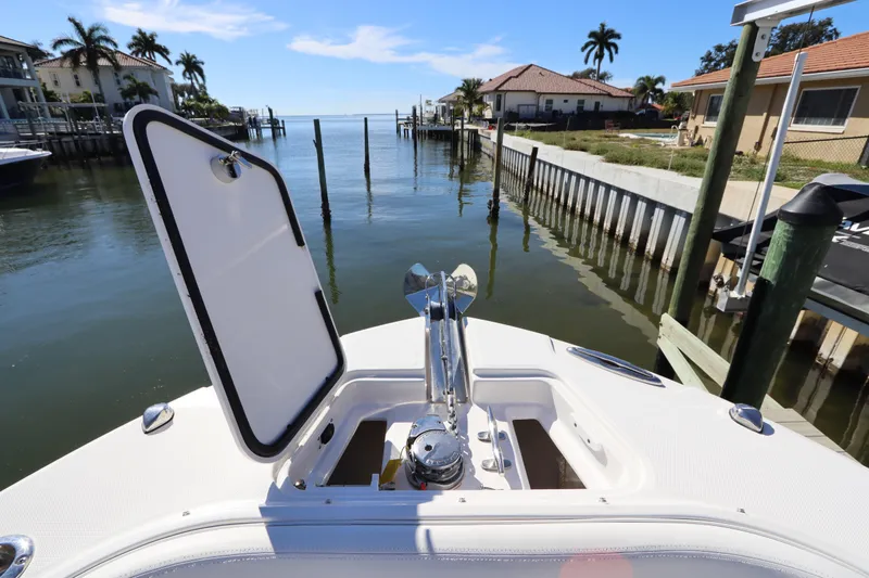  Yacht Photos Pics 2021 Edgewater 262CX Crossover boat docked in a scenic waterfront setting.
