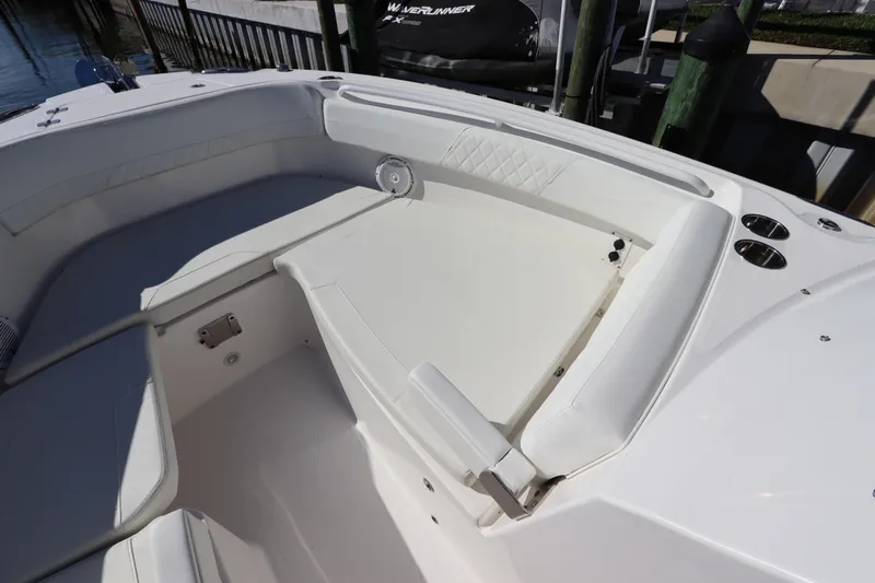  Yacht Photos Pics 2021 Edgewater 262CX Crossover boat interior with white seating and cup holders.