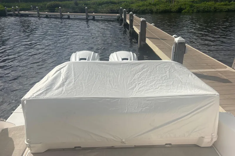 Oh Be Joyful Yacht Photos Pics 2024 Regal 36 XO boat with covered outboard engines at dockside.