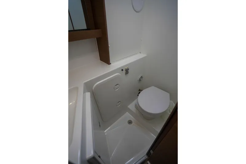 Apres Sail Yacht Photos Pics Compact bathroom in 2019 Lagoon 42 yacht, featuring a toilet and shower area.