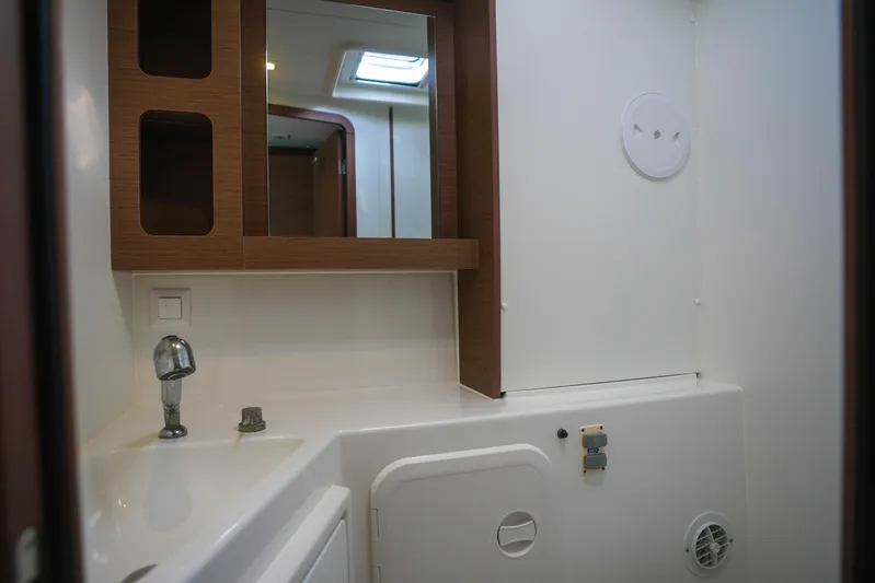 Apres Sail Yacht Photos Pics Bathroom interior of 2019 Lagoon 42 yacht with modern fixtures and wooden accents.