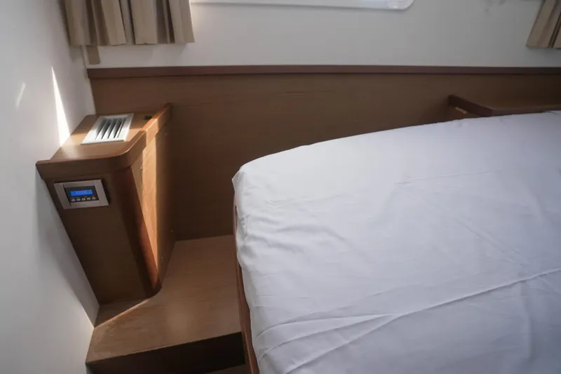 Apres Sail Yacht Photos Pics Interior cabin of 2019 Lagoon 42 yacht with bed and control panel.