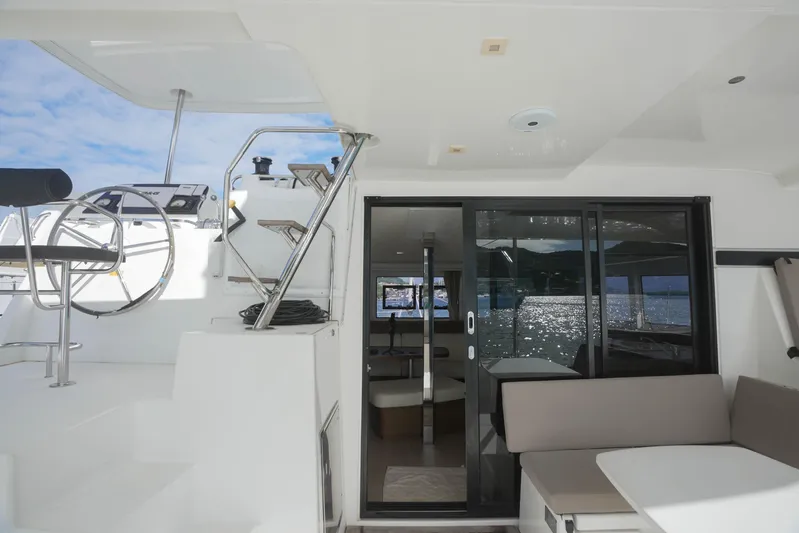 Apres Sail Yacht Photos Pics 2019 Lagoon 42 yacht interior with helm, seating, and ocean view.