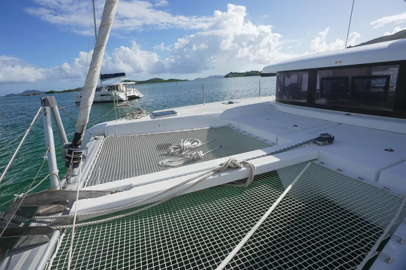 Apres Sail Yacht Photos Pics 2019 Lagoon 42 catamaran on tranquil sea with clear skies and distant islands.