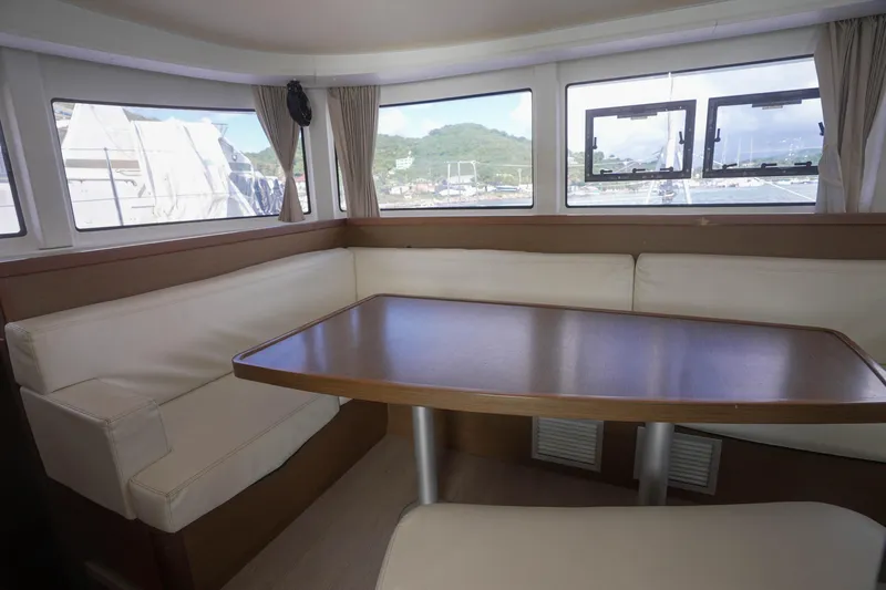 Apres Sail Yacht Photos Pics Interior of 2019 Lagoon 42 catamaran with cozy seating and wooden table.