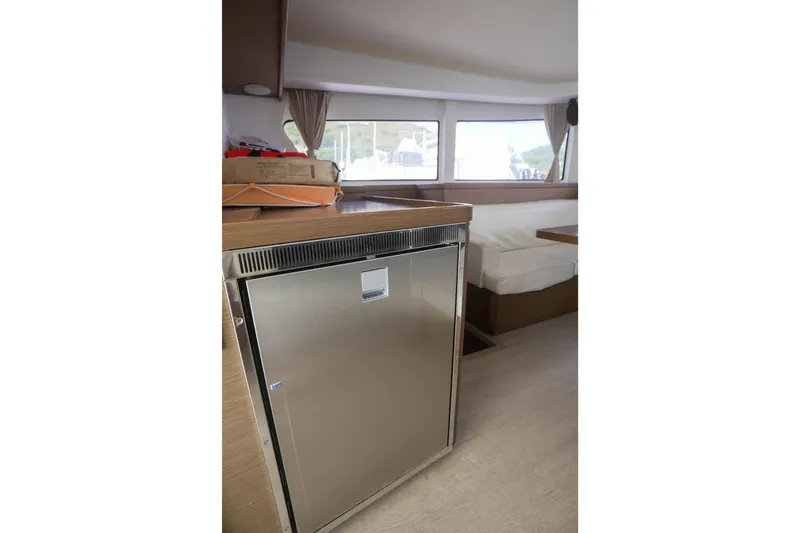 Apres Sail Yacht Photos Pics Interior of 2019 Lagoon 42 catamaran featuring a modern kitchen area with stainless steel fridge.