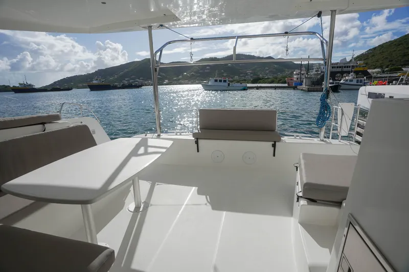 Apres Sail Yacht Photos Pics 2019 Lagoon 42 catamaran deck with seating, table, and scenic harbor view.