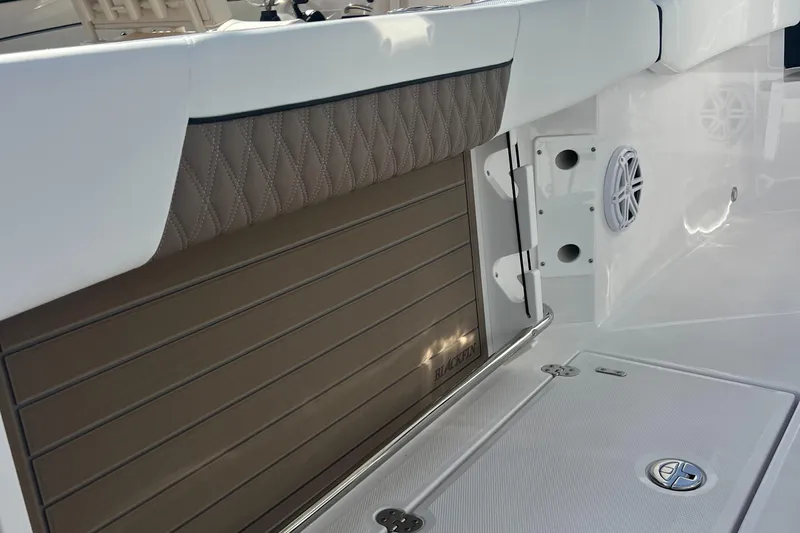 252-449 Yacht Photos Pics 2025 Blackfin 252 CC boat interior with quilted upholstery and speaker detail.