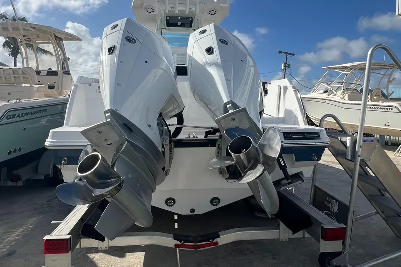 252-449 Yacht Photos Pics 2025 Blackfin 252 CC boat with dual outboard engines on a trailer.